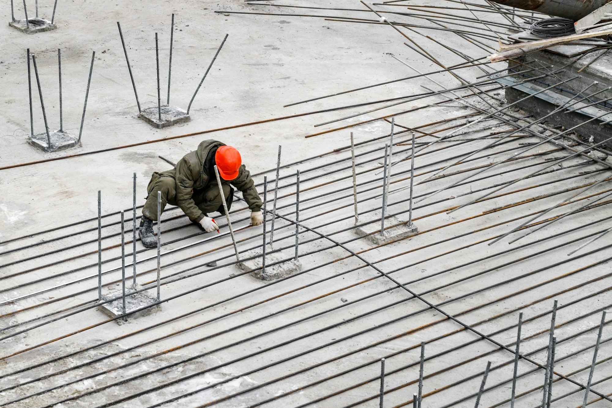 construction specialist makes a marking at the construction site of the house