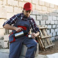 Bricklayer during the coffee break at the work